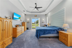 Primary suite with sliders to patio.
