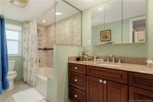 Updated Primary Bath - granite vanity, new tile, shower/tub, lighting, mirror, toilet and plumbing fixtures