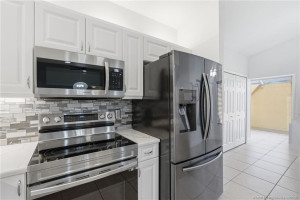 Updated kitchen with quartz countertops and stainless-steel appliances
