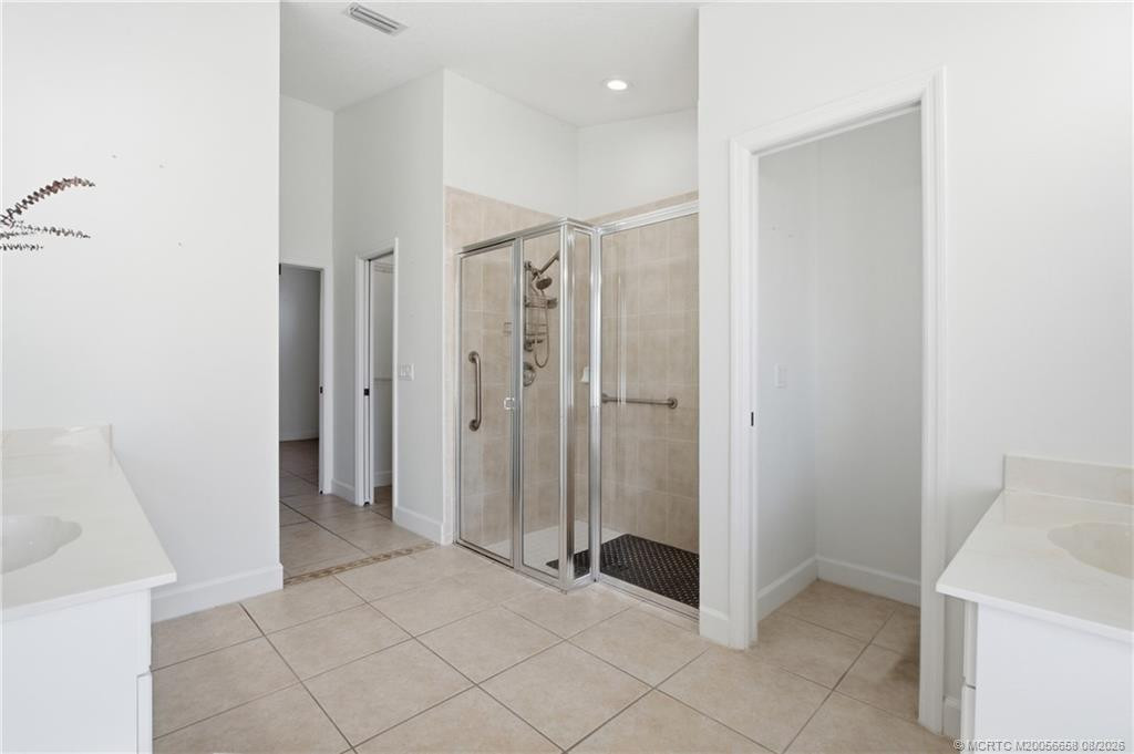 Primary bathroom with walk-in shower and soaking tub.