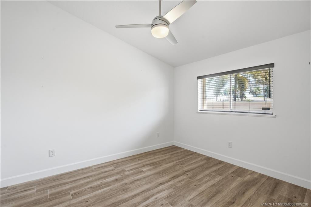 2nd Bedroom: large space with luxury vinyl plank flooring and views of green space.
