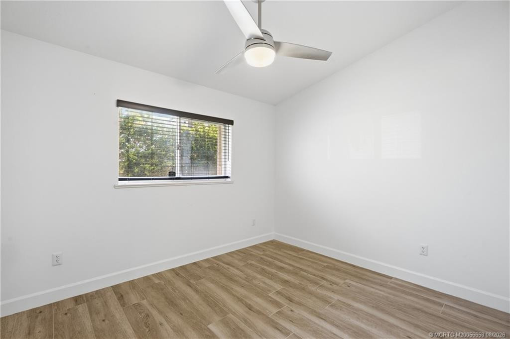 3rd Bedroom: large space with luxury vinyl plank flooring and views of green space.