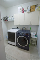 Large laundry room with storage cabinets and hanging space