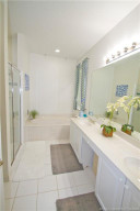 Main Bathroom has a large soaking tub as the focal point. Dual sinks in the vanity with bright lighting.
