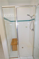 Main Bathroom has a tiled walk in shower with glass enclosure