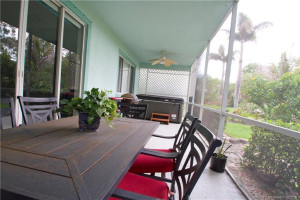 Covered screened rear porch has easy care epoxy flooring.