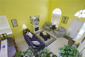 Formal Living Room and Dining room have plenty of light from the half round windows and soaring volume ceiling