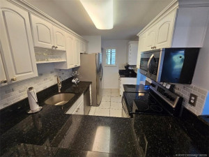 KITCHEN HAS UPDATED CABINETS, GRANITE COUNTERTOPS.
