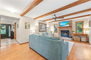 Family room with wood burning fireplace.