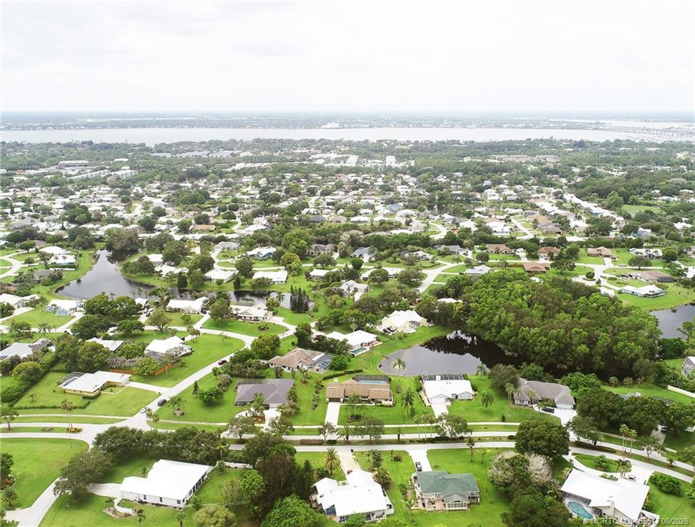 Aerial view from north includes pond, 2nd house from left