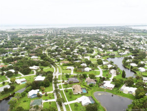 Pool house on right of PCL Blvd, pond to south