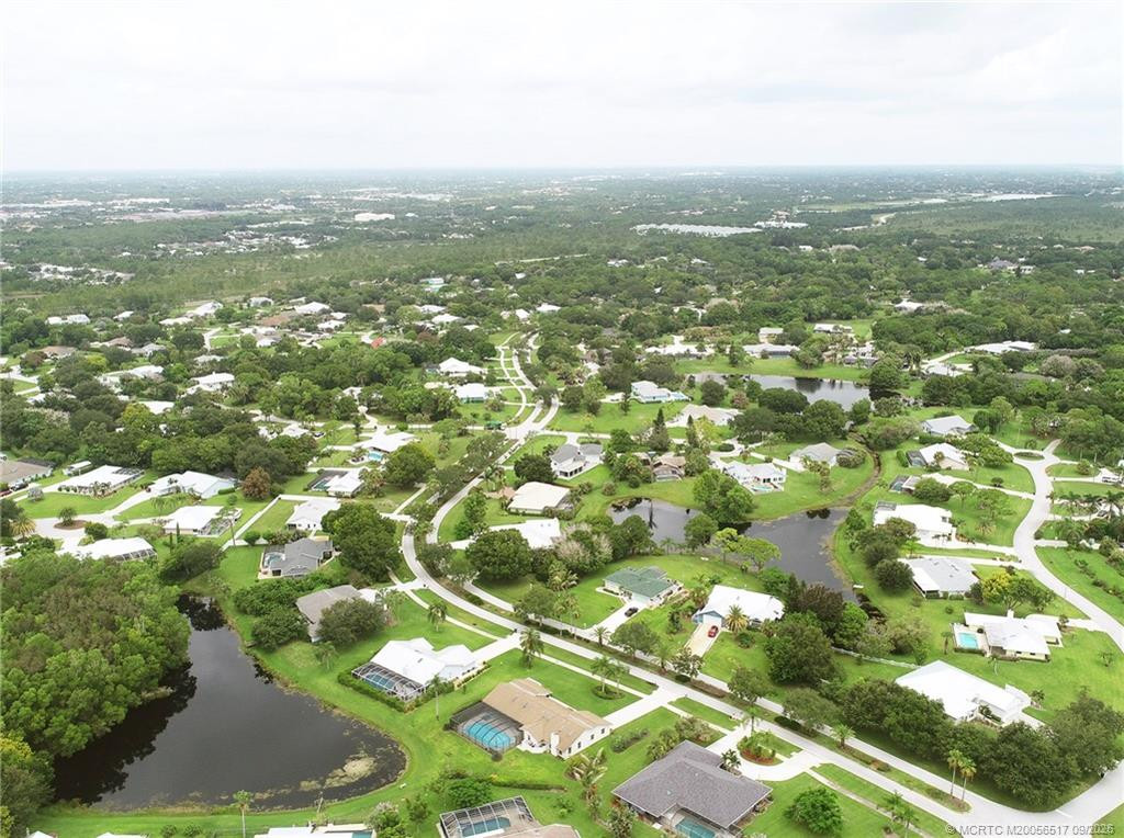 Aerial rear of house at NE side of pond