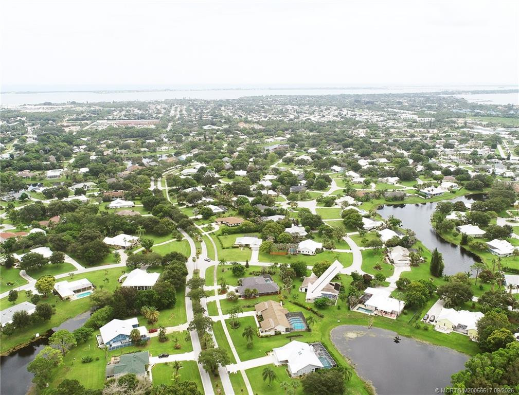 Aerial showing longer lake view behind house, see arrow