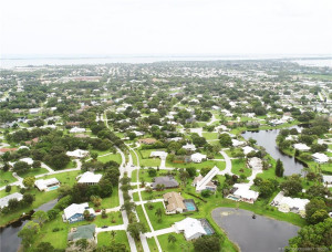 Aerial showing longer lake view behind house, see arrow