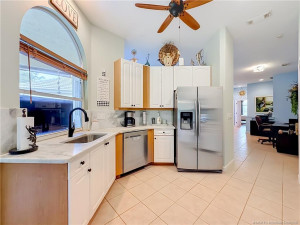 PASS THROUGH TO PATIO FROM THE KITCHEN TO THE SCREENED PATIO, FAN AND STAINLESS APPLIANCES . LARGE STAINLESS SINK