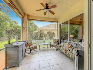 TILE AND 2 SLIDERS TO HOME, PASS THROUGH FROM THE KITCHEN, FAN AND SHADES, SO PRIVATE IN THE BACKYARD.