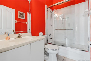 Guest bath between front bedroom and den.