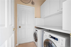 Laundry room between kitchen and garage