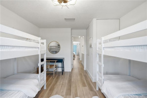 Reverse view highlights the bedroom’s flexible layout, storage, and space for a dedicated desk or work area.