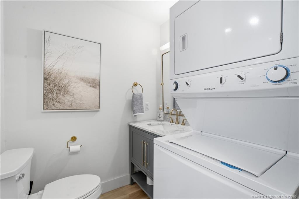 Convenient in-unit laundry is incorporated into the bathroom, with a stacked washer and dryer maximizing the available space.