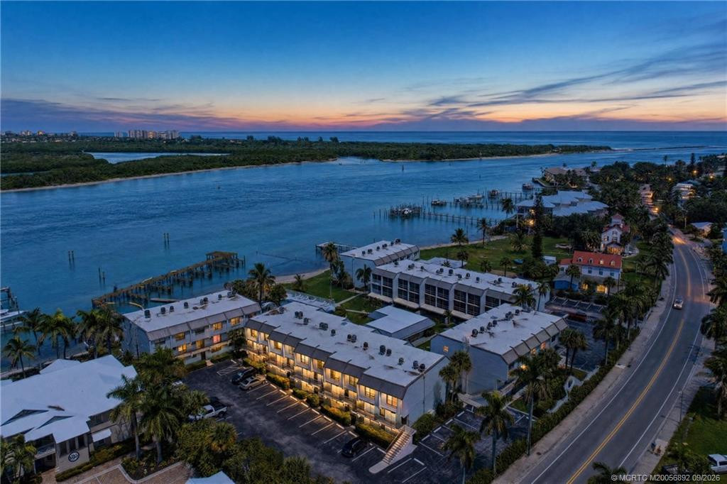 Twilight aerial showcases the community’s waterfront setting along the Intracoastal, with the Atlantic Ocean and Fort Pierce Inlet just beyond.