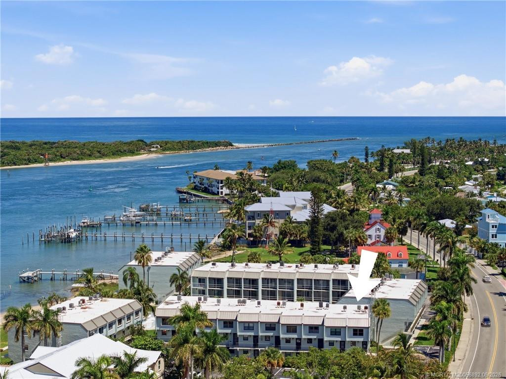 Wide aerial view with arrow identifying the building and showcasing the community’s exceptional proximity to the Fort Pierce Inlet and Atlantic Ocean.