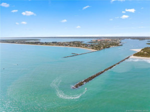 Sweeping aerial perspective captures the inlet, coastline, and expansive waterways surrounding Hutchinson Island.