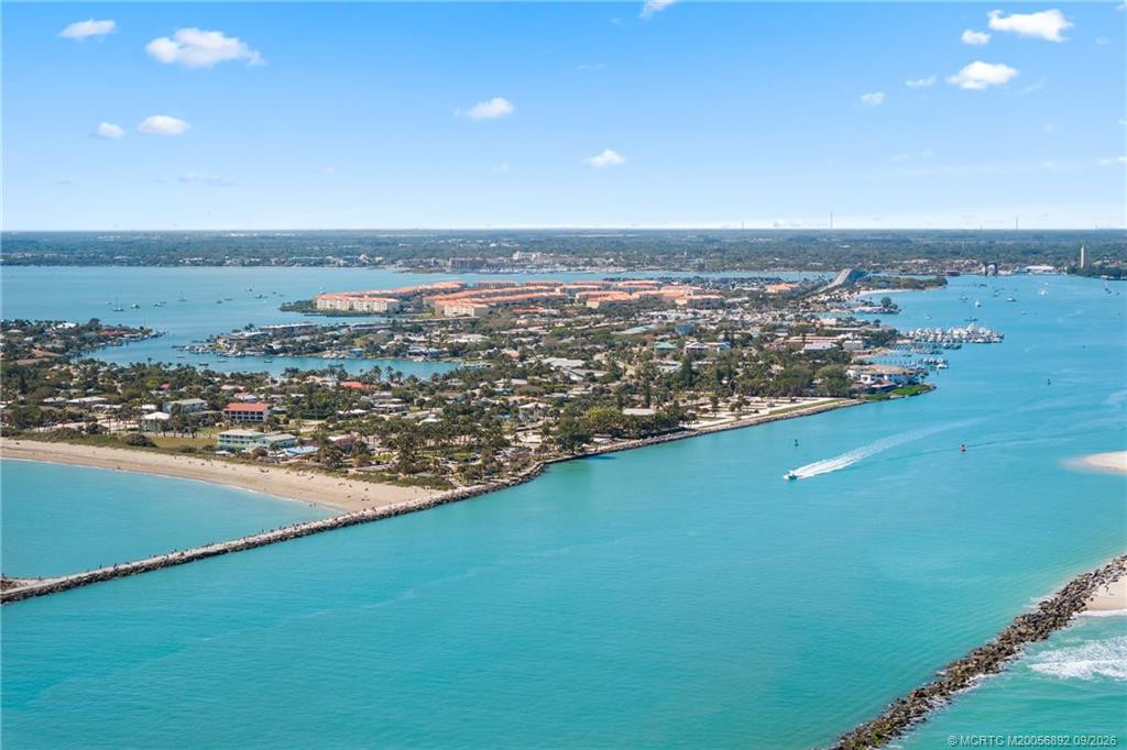Aerial view showcases the Fort Pierce Inlet with Hutchinson Island, beaches, and waterfront communities beyond.