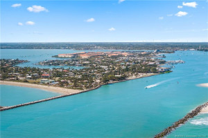 Aerial view showcases the Fort Pierce Inlet with Hutchinson Island, beaches, and waterfront communities beyond.