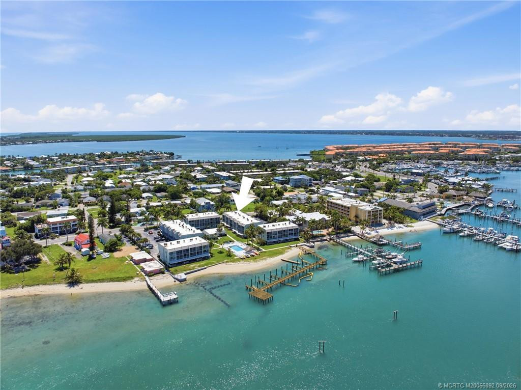Aerial view with arrow identifying the building’s location along the waterfront, surrounded by marinas and coastal waterways.
