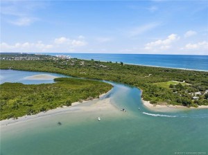 Aerial view of the natural waterways and shoreline near the Fort Pierce Inlet with the Atlantic Ocean beyond.