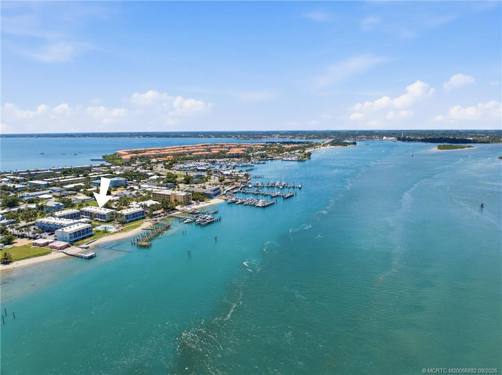 Aerial view with arrow identifying the building and highlighting its proximity to the waterfront and nearby marinas.