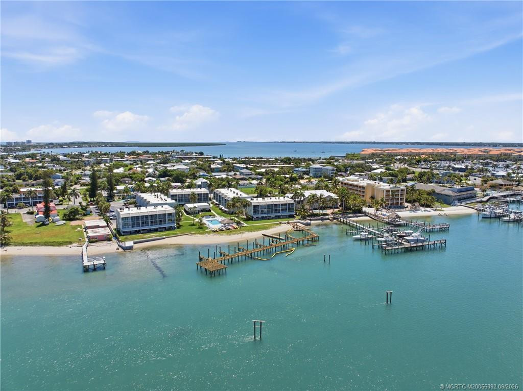 Wide aerial view captures the community along the water with docks, marinas, and the Intracoastal beyond.