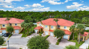 New Metal Roof on townhouse quad, and lots of lush Florida foliage around the townhouse
