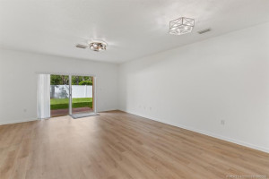 New LVP flooring, upgraded lighting and new vertical blinds at sliding door of patio.