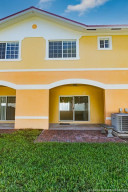 Spacious open brick paver patio extends covered patio outside of sliding glass doors