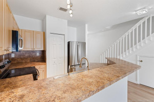 Kitchen has breakfast bar, pantry, and new stainless-steel appliances.