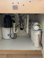 Reverse osmosis and filtered water cartridges under the kitchen sink. Delicious!