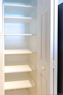 All new adjustable solid shelves in kitchen pantry. Old grid shelving was removed.