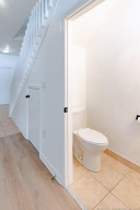 1/2 bath under the stairs and a nice storage closet next to it