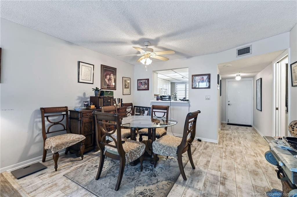 Dining area with pass-through to the kitchen and tile flooring throughout.