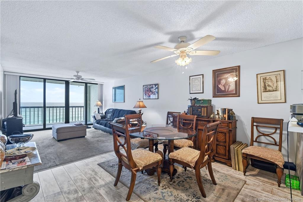 Dining and living areas with direct ocean views and access to the private balcony.