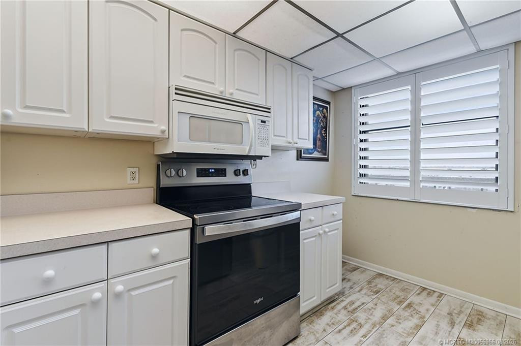 Additional kitchen view featuring generous cabinetry and stainless steel range.