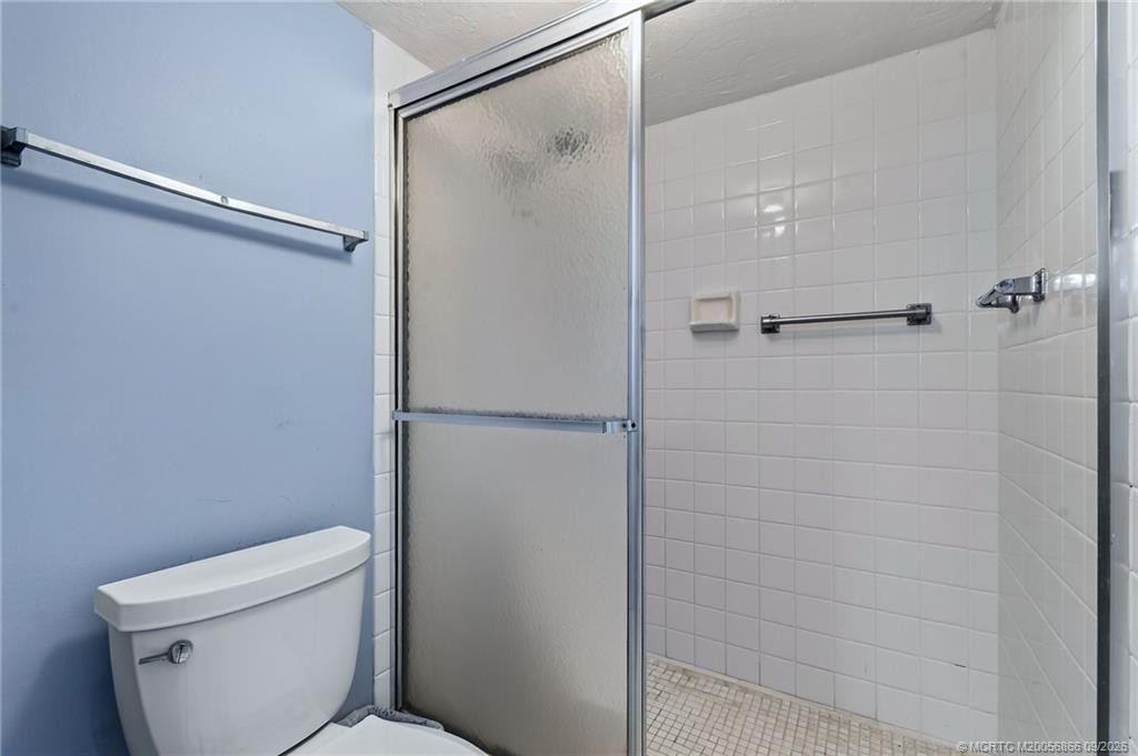 Primary bathroom with tiled walk-in shower.