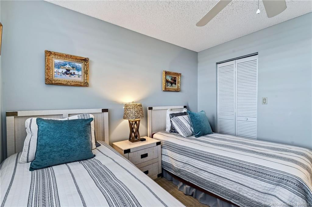 Guest bedroom with twin beds and closet storage.