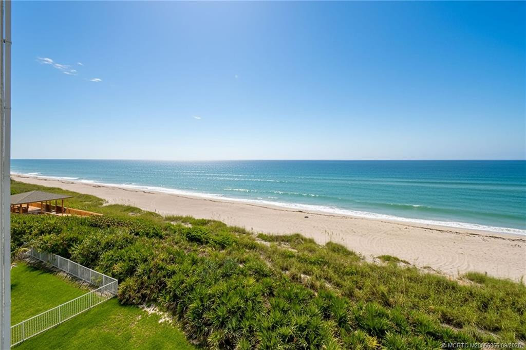 Elevated oceanfront view overlooking the beach and natural dunes.