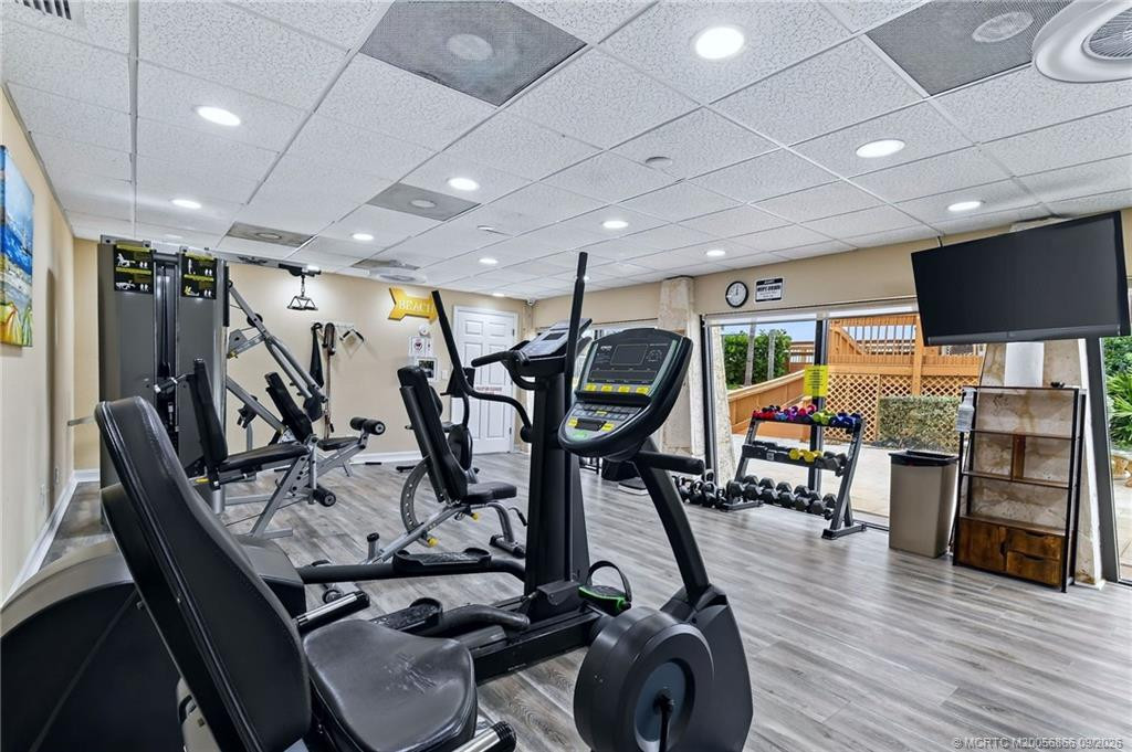 Additional view of the fitness center with cardio and strength-training equipment.