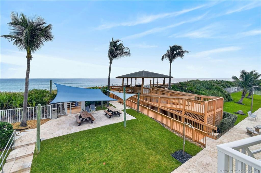 Private beach access with an oceanfront pavilion and seating area overlooking the Atlantic.