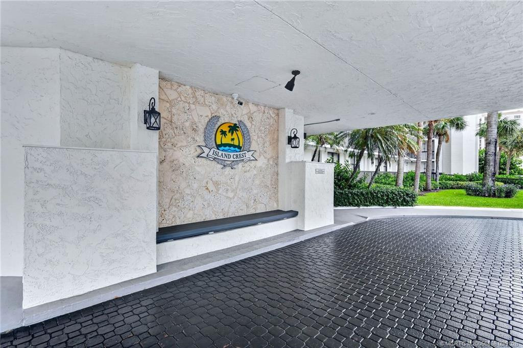 Covered Island Crest entrance with tropical landscaping.