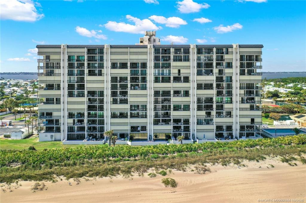 Aerial view of the Island Crest condominium building directly along the Atlantic Ocean.